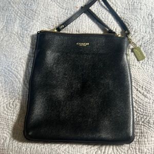 Coach leather black crossbody with 1 front pocket. 2 small interior pockets also